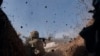 Ukraine -- A Ukrainian soldier of the 28th brigade fires a grenade launcher on the frontline during a battle with Russian troops near Bakhmut, Donetsk region, Ukraine, Friday, March 24, 2023.