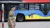 LITHUANIA – A NATO bus reading "Arm Ukraine" and "While you are waiting for this bus, Ukraine is waitng for F-16s" is parked on the site of the NATO summit, in Vilnius on July 11, 2023
