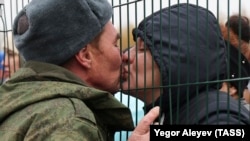A man and woman kiss at a farewell ceremony at a mobilization center in Kazan in October.