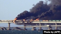 Black smoke billows from an explosion on the Kerch Bridge that links Crimea to Russia on October 8, 2022.