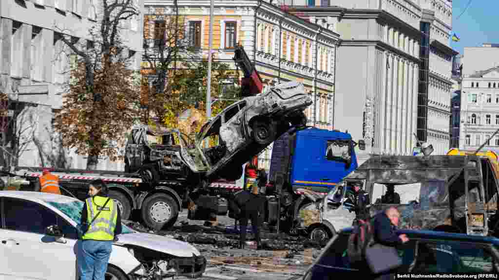 Uklanjanje automobila na Ševčenko bulevaru, uništenih u ruskom raketnom napadu na Kijev.