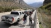 People walk by a line of vehicles on the road for the Verkhny Lars checkpoint on the Russian-Georgian border in September 2022. According to the Georgian Interior Ministry, around 78,000 Russians arrived in Georgia from September 17-26. 