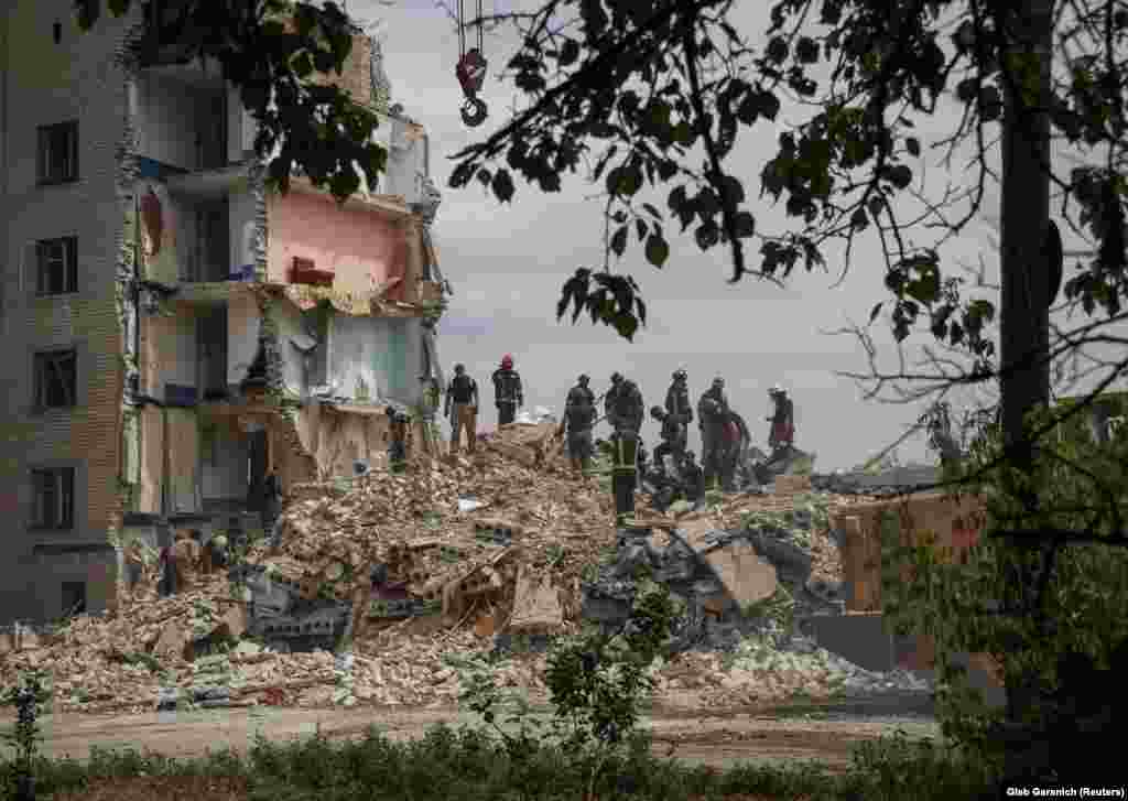 Ukrainian rescue crews search through the ruins of the apartment block in Chasiv Yar. Ukrainian authorities fear people could still be trapped in the rubble. The town has about 12,000 inhabitants and is around 20 kilometers southeast of Kramatorsk, a city that recently has been a target of Russian forces.