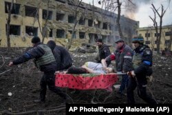 Ukrajinska hitna pomoć i volonteri nose trudnicu ranjenu u napadu na porodilište u Mariupolju, 9. mart.