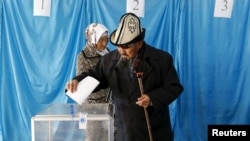 Kazakhs vote during snap parliamentary elections in the southern village of Toretam on March 20.