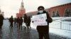 Oleg Kashintsev, a former Russian policeman, holds a placard reading "Free Navalny! Putin is a killer!" on Moscow's Red Square in 2021.