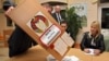 Electoral commission staff empties a ballot box in the capital, Minsk, after polling stations closed in Belarus's parliamentary elections on September 23.