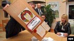 Electoral commission staff empties a ballot box in the capital, Minsk, after polling stations closed in Belarus's parliamentary elections on September 23.