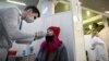 A woman undergoes a rapid antigen test for Covid-19 at a testing center in Moscow.