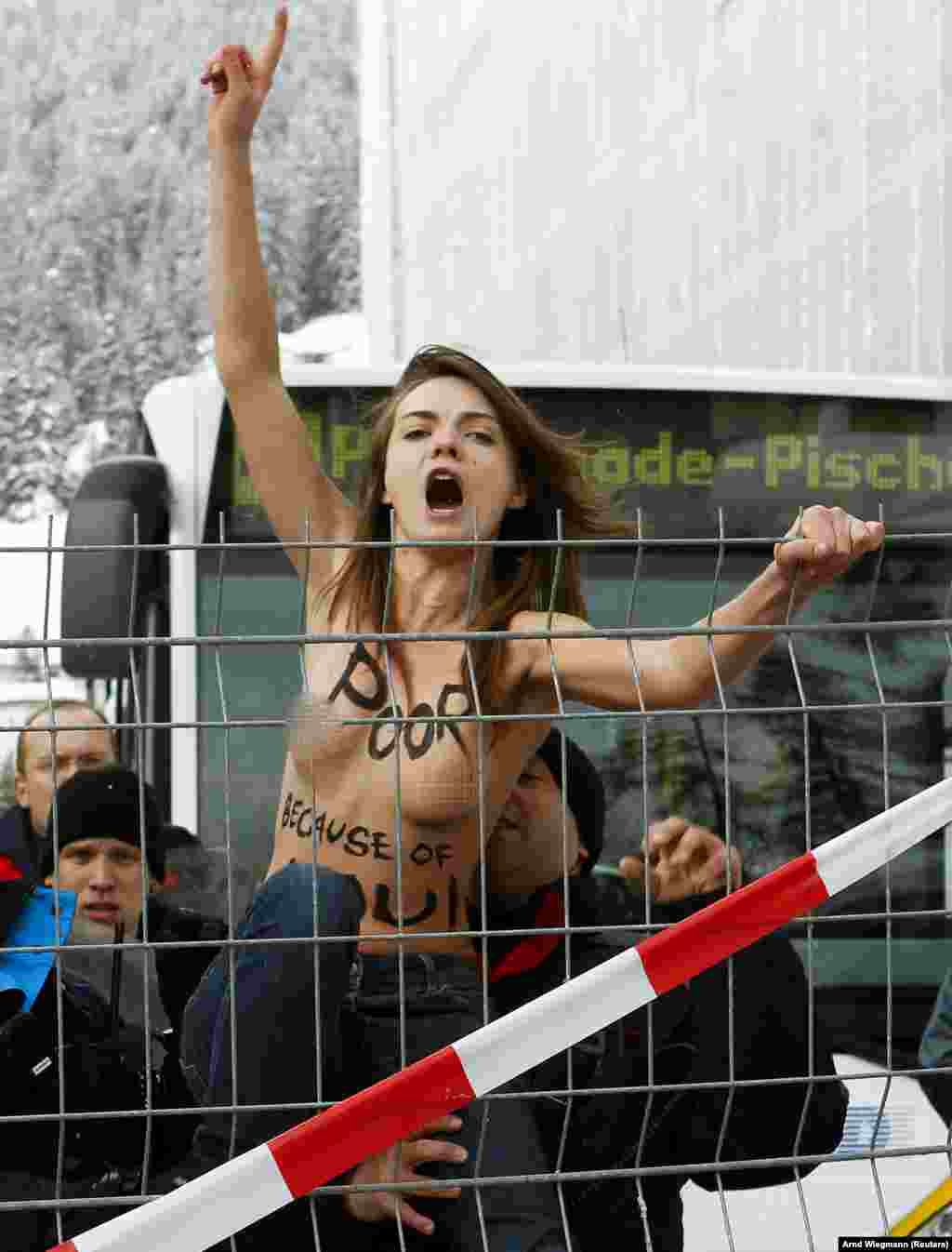 Swiss policemen detain Shachko during a protest at the World Economic Forum in Davos in 2012. Femen co-founder Anna Hutsol told RFE/RL amid the reports of her suicide, &quot;As far as I know, she was concerned that everything was going badly in the world.&quot;