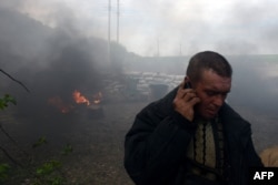 A man talks on the phone as he flees a checkpoint after Ukrainian special forces took up positions in the city of Slovyansk.