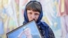 Учасниці ходи поклали квіти і поставили лампади до &laquo;Народної Стіни Пам&rsquo;яті&raquo;