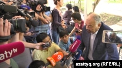 Tungyshbai Zhamanqulov speaks to reporters after his trial in Almaty on June 1.