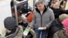 Немцов раздает листовки оппозиционного марша "Весна" 