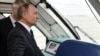 Russian President Vladimir Putin rides a train across the Kerch Bridge in December 2019.