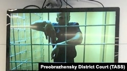 Aleksei Navalny is seen on a screen via a video link during a court hearing in Moscow in June 2021.