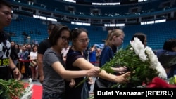 Mourners place flowers at a ceremony in Astana for Denis Ten.