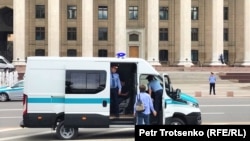 A police bus waits in Astana Square.