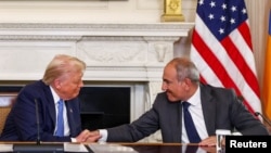 U.S. President Donald Trump shakes hands with Armenia's Prime Minister Nikol Pashinian during a trilateral signing event at the White House, Washington, August 8, 2025. 