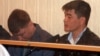 Одни из подсудимых - сотрудники полиции в зале суда, Актау, 27 апреля 2012 года. 