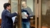 Russian opposition leader Vladimir Kara-Murza (right), talks to his lawyer Vadim Prokhorov during a preliminary court hearing in Moscow on March 6.