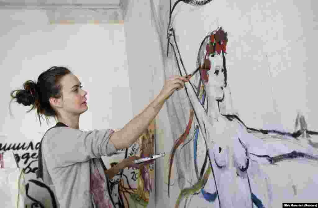 Shachko paints a wall of her room in Kyiv in 2012. According to Reuters, Shachko studied iconography in the city of Khmelnitsky in western Ukraine.