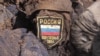 Иллюстрационное фото. Шеворн воруженных сил России на форме погибшего боевика. Луганская область, июнь 2016 года