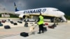 BELARUS -- Security with a sniffer dog check the luggage of passengers in front of Ryanair Boeing 737-8AS (flight FR4978), carrying opposition figure Raman Pratasevich, in Minsk, May 23, 2021