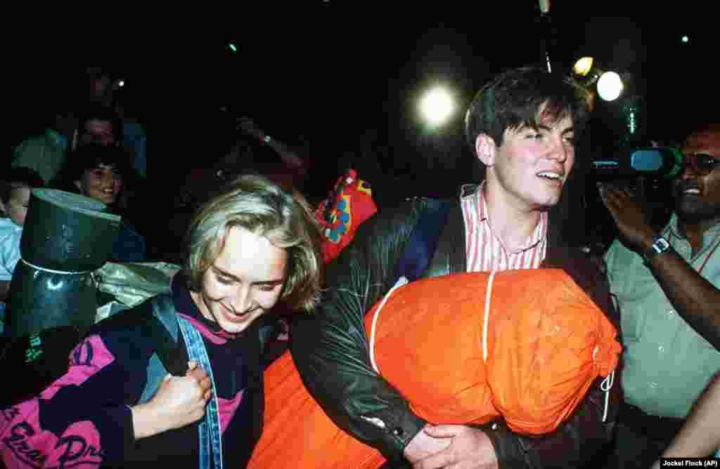 East Germans leave the Zugliget camp in Budapest on September 10 after hearing that they would be allowed to leave Hungary that night. At midnight, the Hungarian government announced that it would open its borders to East German &quot;tourists&quot; without the approval of the East German or Soviet leadership.