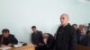 Умар Мирзоев, аз тарафи рост нафари дуюм бо либоси сиёҳ, ки чеҳраашро пинҳон кардааст