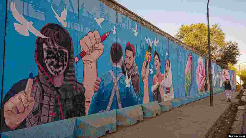 A mural in Kabul featuring a woman voter that has been spray-painted to cover her face &nbsp;