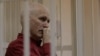 Ales Byalyatski sits in a Minsk court during his trial in November 2011.