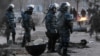 Riot police patrol Zhanaozen in December.