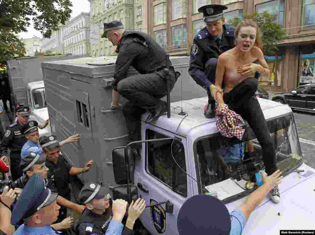 Policemen detain Shachko on the roof of a police wagon to transport detainees during a protest rally outside a court in Kyiv in 2011. Femen staged a protest against what they said was the targeting of former Ukrainian Prime Minister Yulia Tymoshenko.