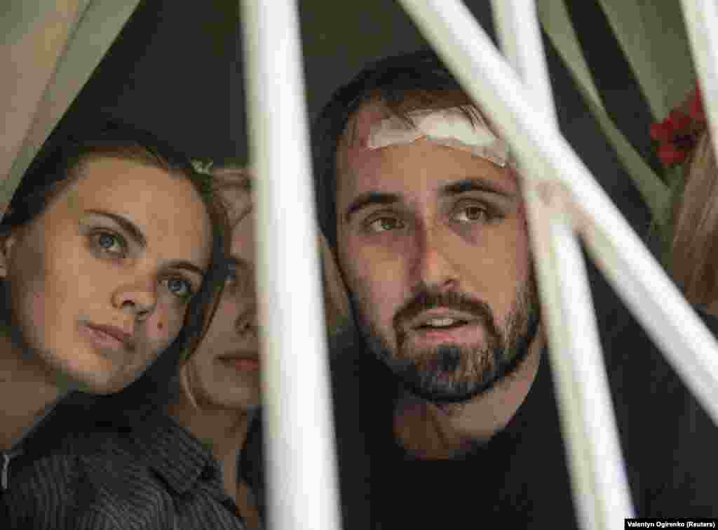 Shachko (left) during the 2013 court hearing. The Femen activists were reportedly kidnapped and beaten while on their way to protest a visit to Ukraine by Russian President Vladimir Putin, a frequent target.