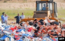 A worker uses a bulldozer to crush crates of peaches outside the city of Novozybkov earlier this month. (file photo)