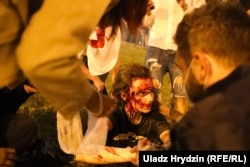 A demonstrator who'd been beaten by police sits on the street in Minsk during the first postelection protest on the night of August 9-10.