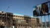 Пострадавшее здание офиса компании «Озенмунайгаз» и испорченный билборд с изображением президента Назарбаева. Жанаозен, 19 декабря 2011 года. 
