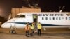 A crew member opens the door of a Greek airliner in Skopje airport on November 1 after the first direct flight between Athens and the Macedonian capital in 12 years. 