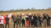 Участники митинга скромно держали плакаты в опущенных руках, пока осетинская журналистка, которой нужен был хоть один хороший кадр для своего агентства, жестами не попросила поднять их над головой