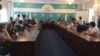 Protesters talk with a representative of the Nur-Otan party in Almaty on May 21. 