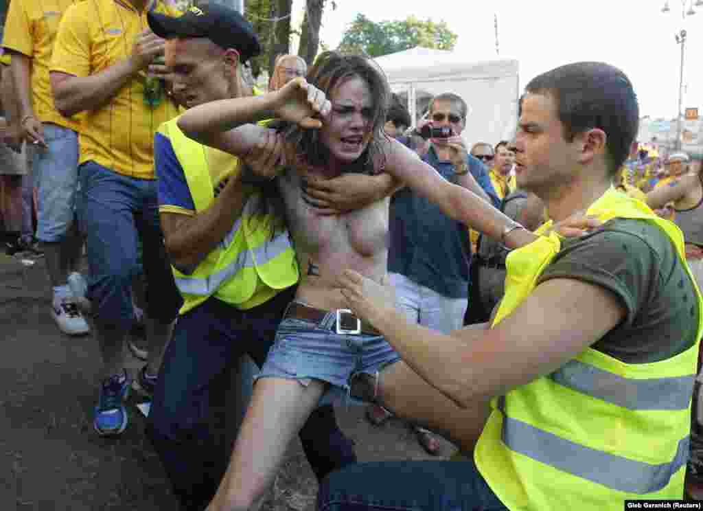 Security guards grapple with Shachko during the Euro 2012 protest.&nbsp;