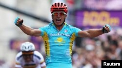 Kazakhstan's Aleksandr Vinokurov celebrates as he wins the men's cycling road race to claim the gold medal at the London 2012 Olympic Games on July 28.