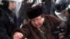 Оппозиционного политика Серика Сапаргали задерживает полиция на акции протеста в Алматы, 17 декабря 2011 года. 
