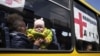 A woman with a child from Siversk look though the window of a bus during evacuation near Lyman, Donetsk region, in May.