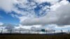 Georgia --- A warning sign is pictured behind a newly constructed fence along Georgia's de-facto border with its breakaway region of South Ossetia in the village of Dvani, October 4, 2013