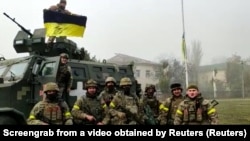 Soldiers of Ukraine's 131st Separate Reconnaissance Battalion celebrate the liberation of the city of Snihurivka, in the Mykolayiv region, from Russian occupying forces on November 10.
